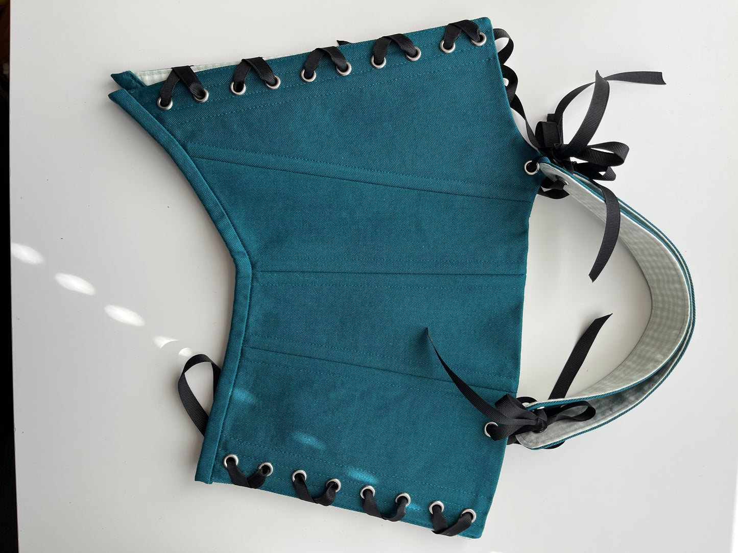 Teal corset with front and back ties, removable shoulder straps,